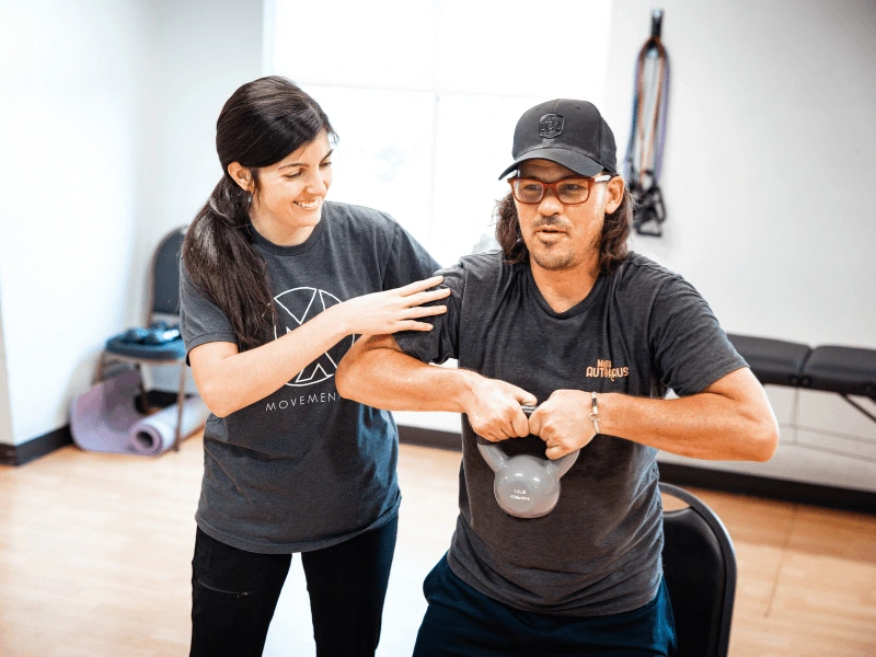 Lauren Scott MovementX Physical therapist in Chattanooga Tennessee working with a male patient on neuro PT rehab in a gym setting