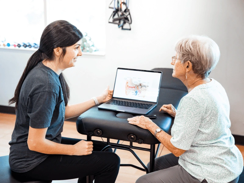 Lauren Scott MovementX Physical therapist in Chattanooga Tennessee talking with a female about stroke recovery in a PT clinic setting