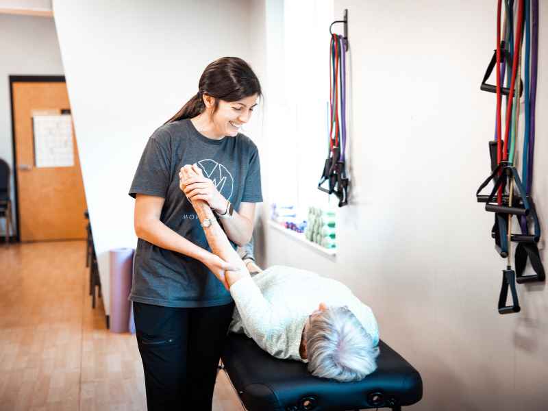 Dr. Lauren Scott helping a MovementX patient move through mobility assessments following a car accident.