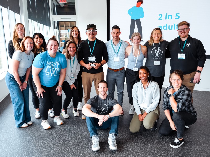 a large group of movementx physical therapists smiling together as a team