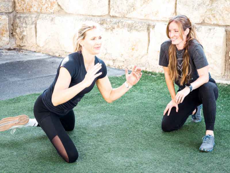 A female MovementX physical therapist helping a patient navigate hip pain and mobility during a treatment session in the Austin, Texas area.