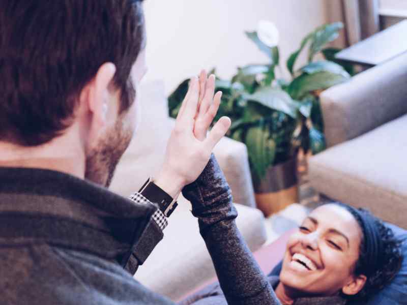 Josh D'Angelo, PT, DPT and CEO of MovementX high fiving a patient after a treatment in-home in Washington, D.C.