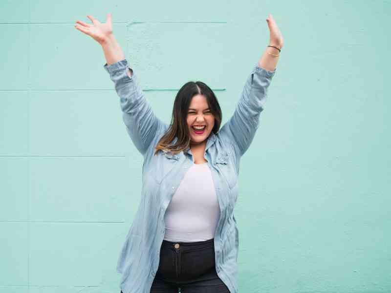 A woman with lipedema celebrating a holistic treatment plan with MovementX.