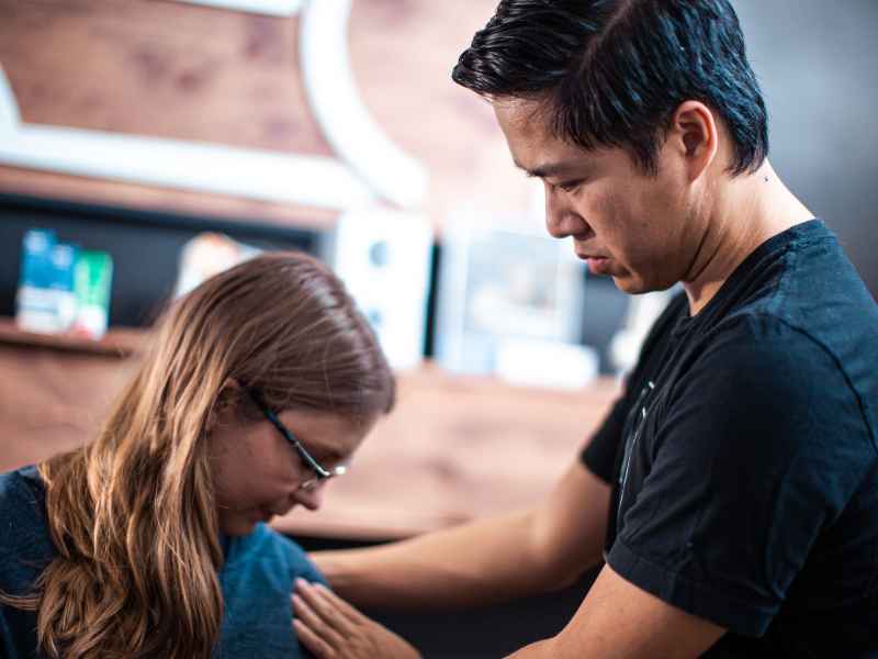Dr. Peter Nguyen helping a patient familiarize themselves with CCI treatments and physical therapy in Orange County, CA