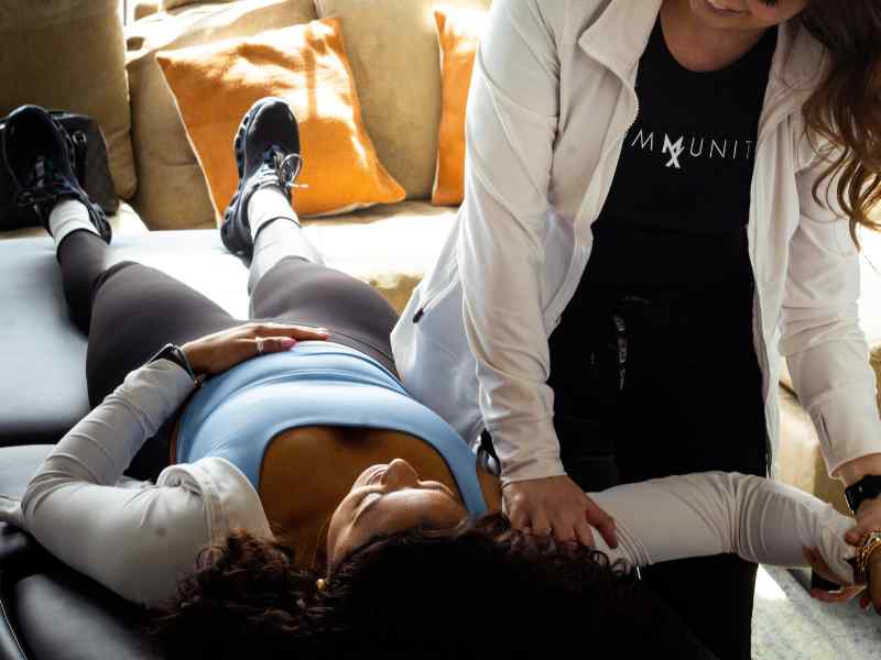 A MovementX provider helping a patient in Knoxville, TN work through a hypermobility evaluation.