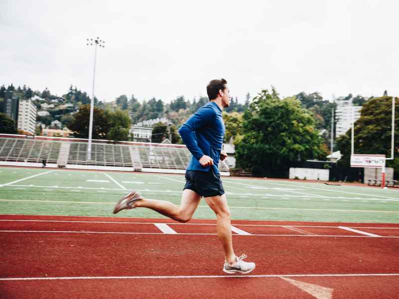 A runner doing micro-adjustments during a track run during a MovementX treatment session with Cesar Laboy.
