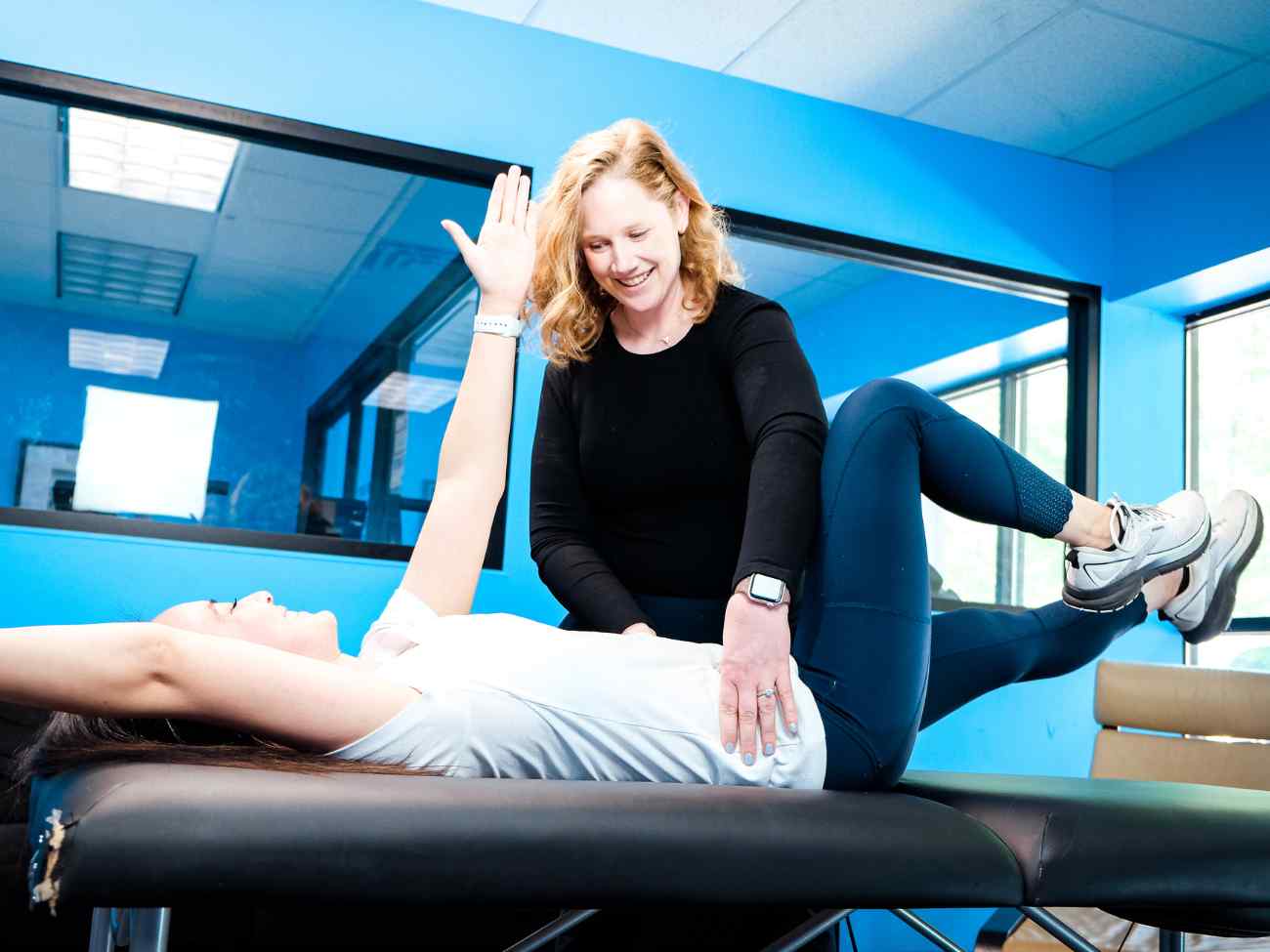 MovementX provider McCaul Butcher, PT, DPT helping a female patient navigate pelvic health changes during a session in Leesburg, VA.