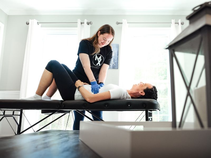 Morgan Groover, PT, DPT helping a patient do an endometriosis physical exam during an in-home physical therapy session in Virginia.