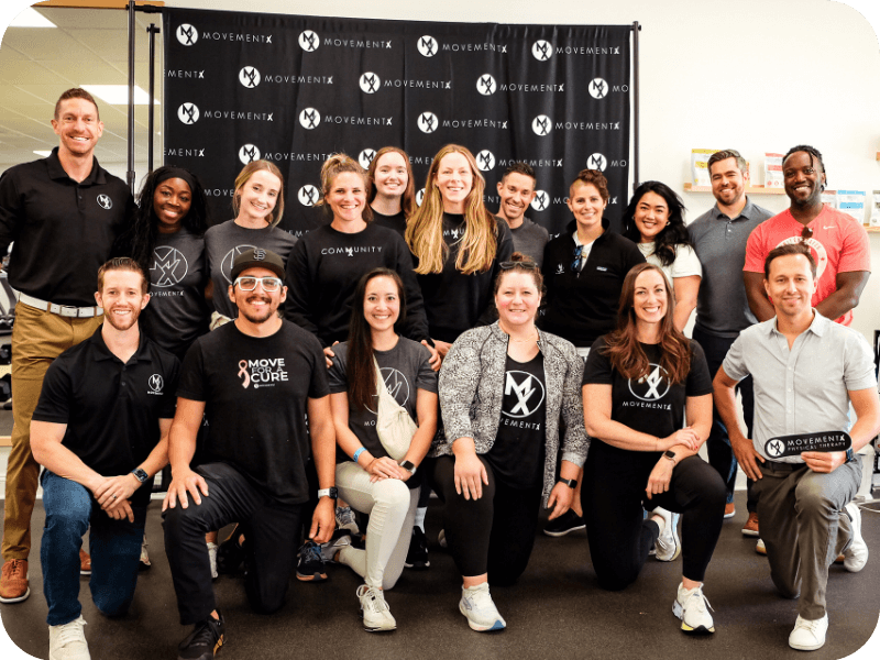 a large team of movementx physical therapists enjoying their PT careers with movementX in a PT clinic setting