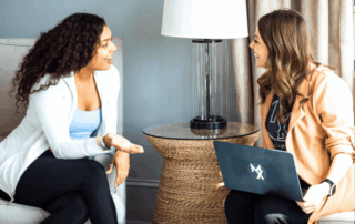 two knoxville physical therapists talking with each other in a clinic setting