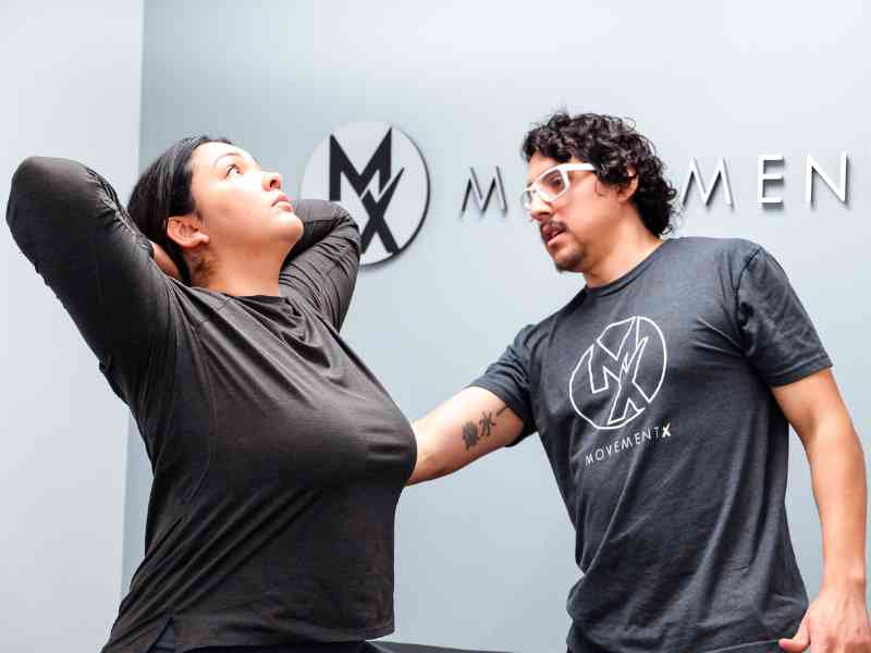 Rich Ortiz, PT, DPT helping a patient mobilize her thoracic spine during an in-home session in Washington D.C.