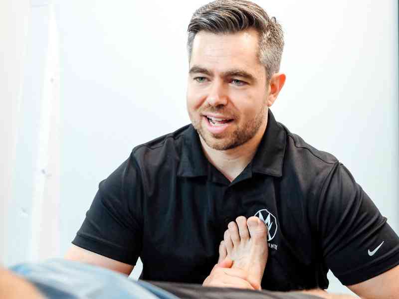 James Cousler, PT, DPt helping a patient address their Achilles pain during a treatment session in Virginia.