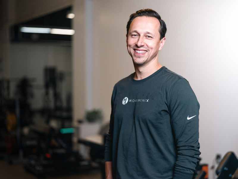 Kris Porter, PT, DPT standing in a gym.