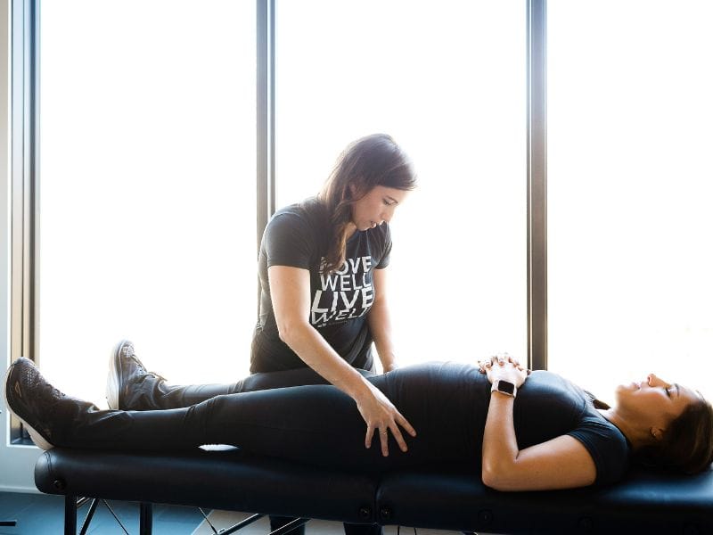 MovementX provider Kaylene Hernandez helping a patient during a pelvic health assessment