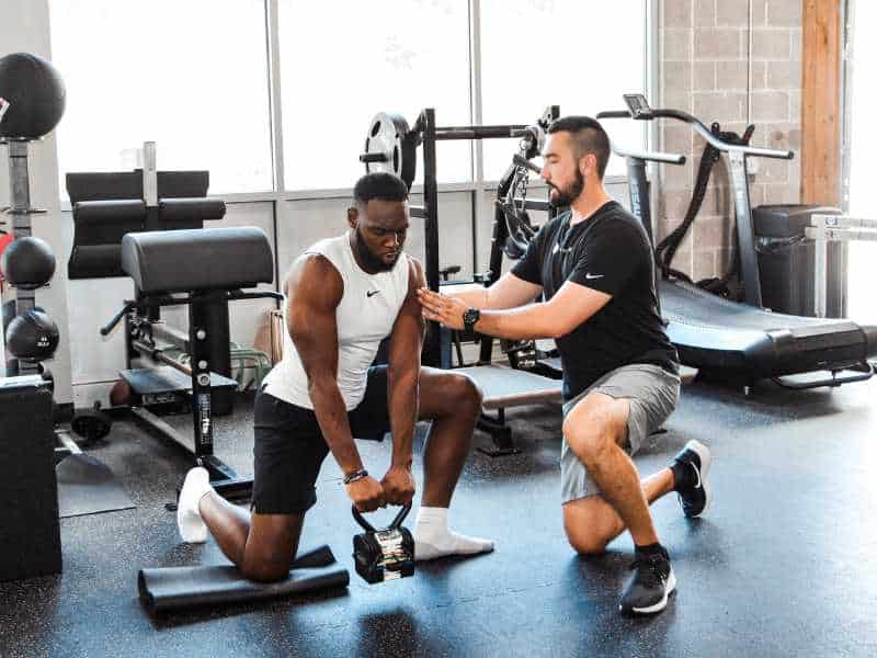 MovementX provider Patrick Dumais, PT, DPT helping a basketball athlete rehab in a gym in Pittsburgh, PA