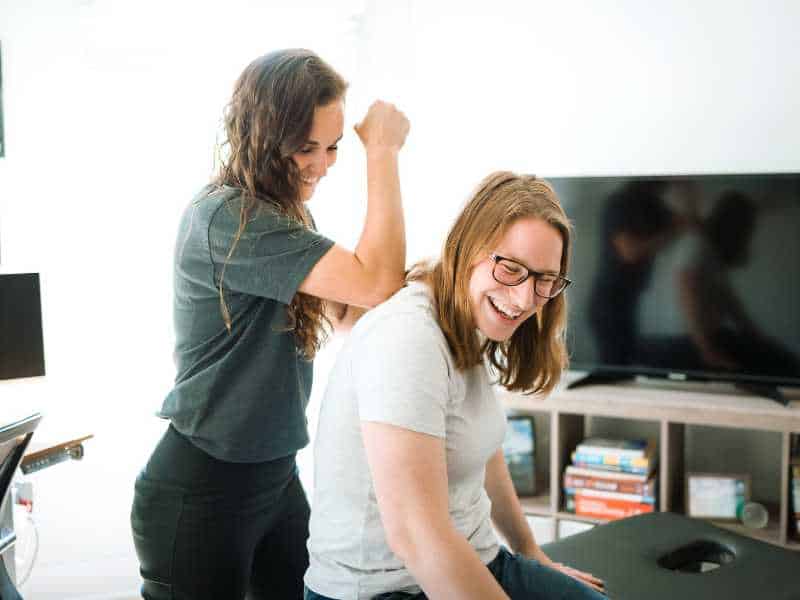 MovementX provider Ashton Grimm, PT, DPT helping a patient mobilize her shoulder on a treatment table in Knoxville, TN