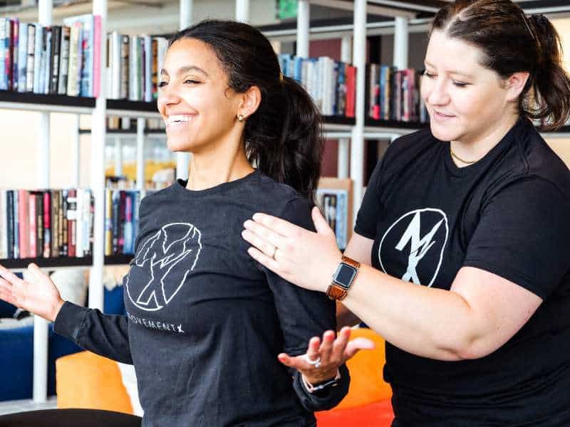MovementX Provider Annie Martucci helping a patient assess shoulder and thoracic mobility.
