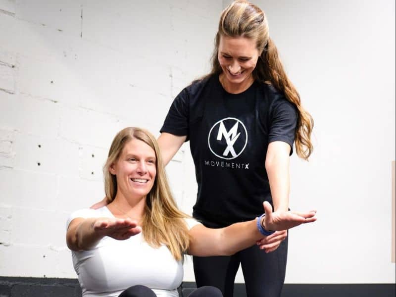 Sarah Taylor, PT, DPT helping a patient in Northern Virginia do set of pelvic health exercises on a medicine ball.